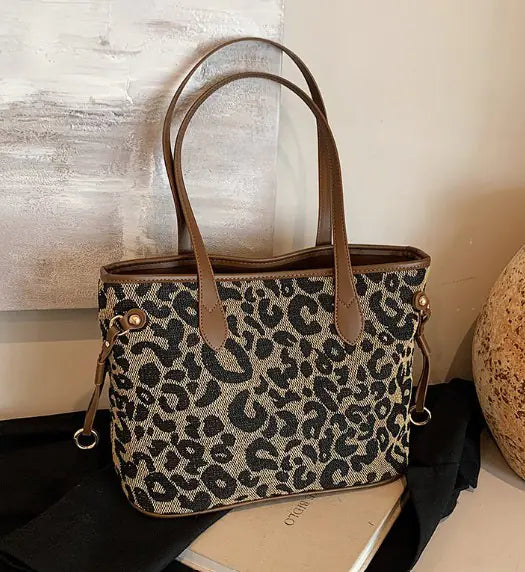 Leopard print Shoulder Tote Bag featuring brown leather handles and side rings, perfect for fashion-forward functionality.