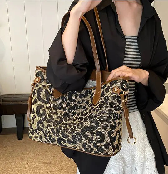Model holding a brown-handled leopard print Shoulder Tote Bag, combining fashion and practicality for daily wear.