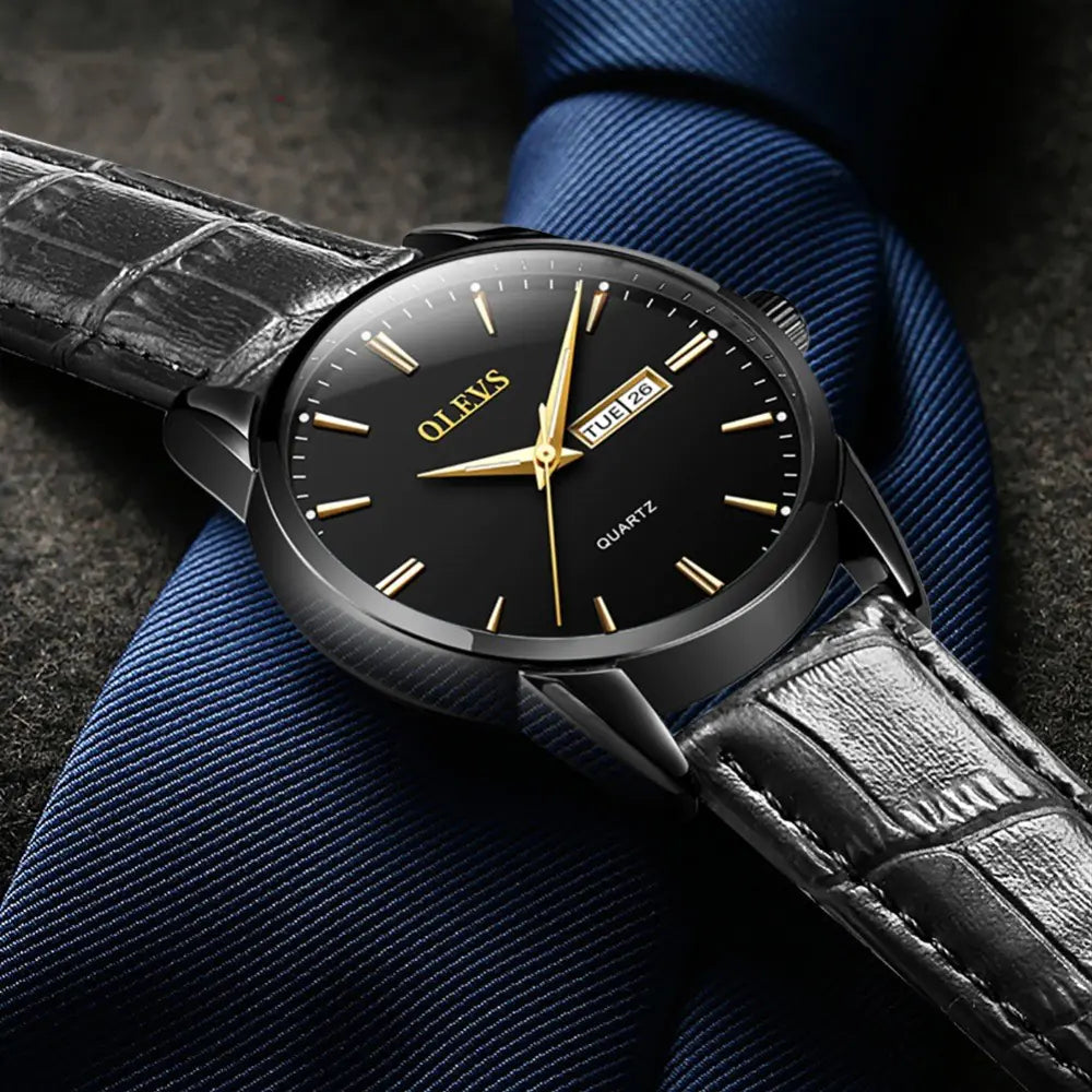 Black Quartz Couple Watch - Men's Mechanical Dual Calendar with gold accents, paired with a black leather strap and formal attire.