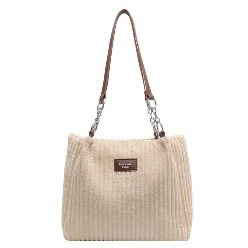 Beige corduroy shoulder tote bag with ribbed texture and spacious design, combining retro elegance with practical everyday functionality.