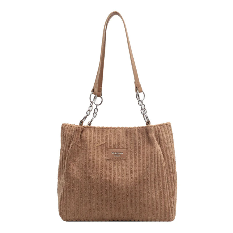Tan corduroy shoulder tote bag with roomy interior and retro-inspired design, ideal for carrying essentials in casual settings.