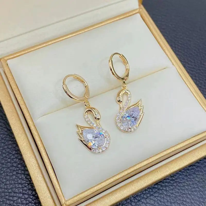 European Style Luxury Temperament Copper Zirconium Swan Pendant Earrings in a jewelry box, highlighting their fashion-forward floral design.