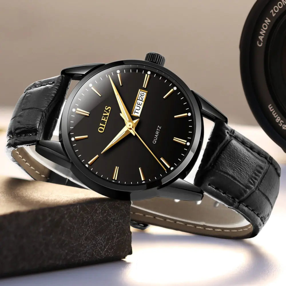 Black Quartz Couple Watch - Men's Mechanical Dual Calendar with gold markers and black leather strap, styled for professional wear.