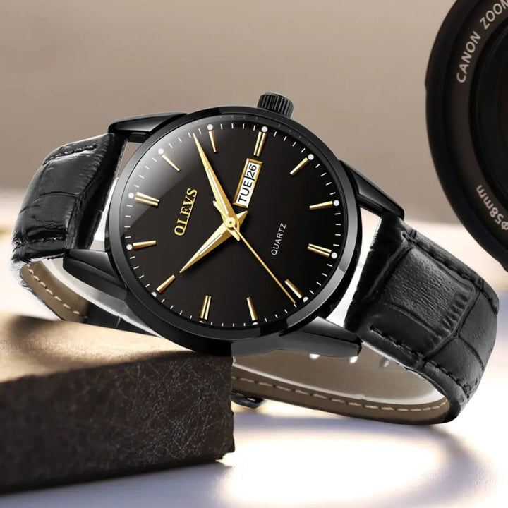 Black Quartz Couple Watch - Men's Mechanical Dual Calendar with gold markers and black leather strap, styled for professional wear.