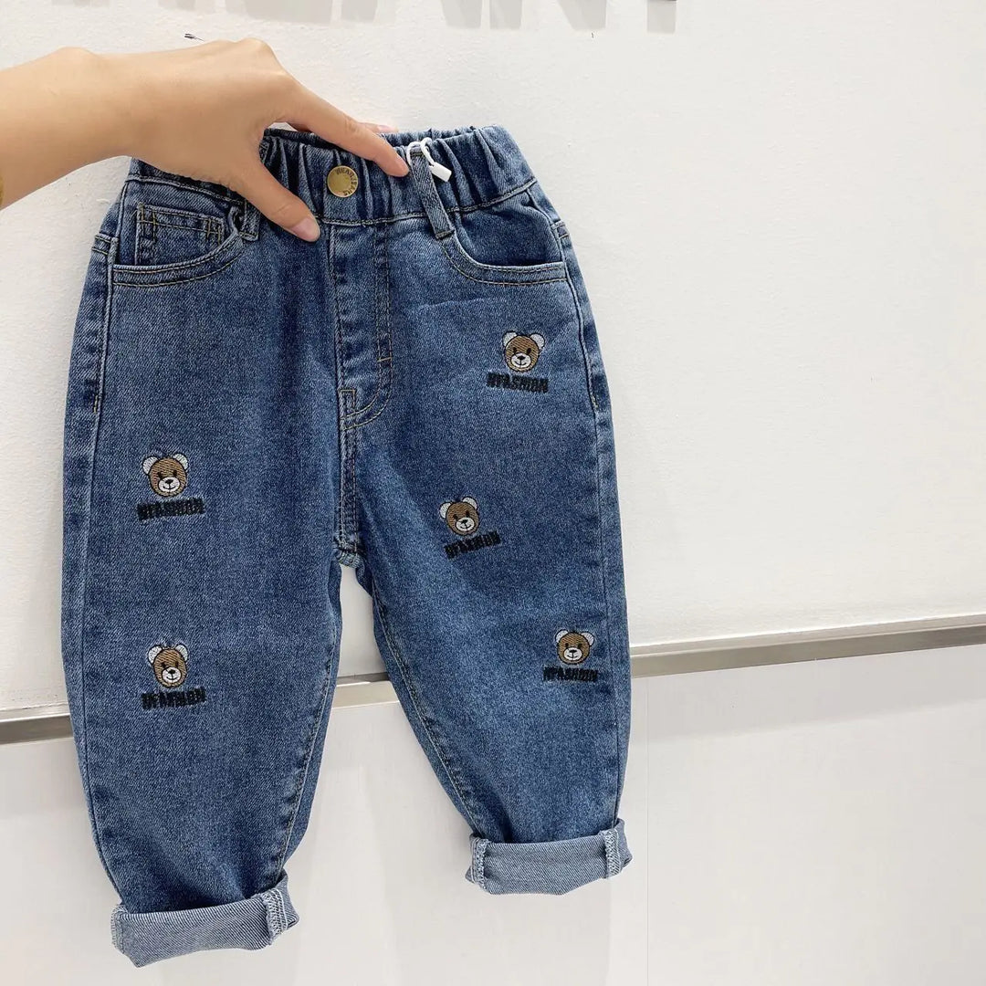 Blue kids' casual all-match long pants with teddy bear embroidery, combining comfort and trendy Korean-inspired design.