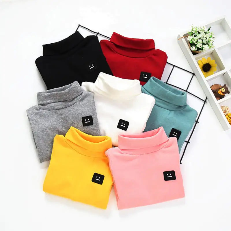 Assorted New Baby Long-Sleeved T-Shirts for Kids' Tops in multiple colors including yellow, red, black, and teal, ideal for mix-and-match outfits.