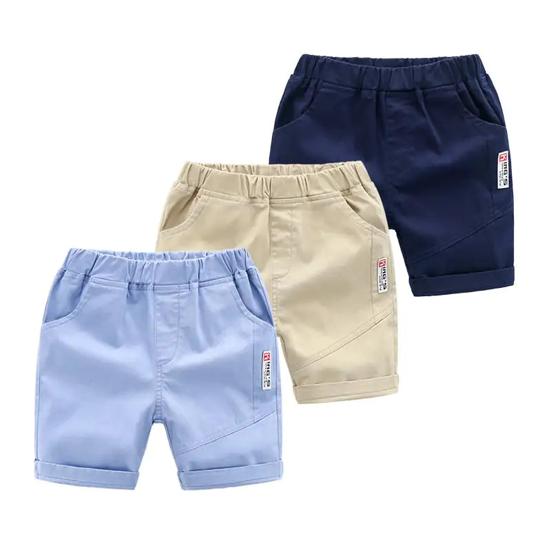 Set of three trendy summer casual pants for kids in navy, beige, and light blue, perfect for versatile summer outfits.
