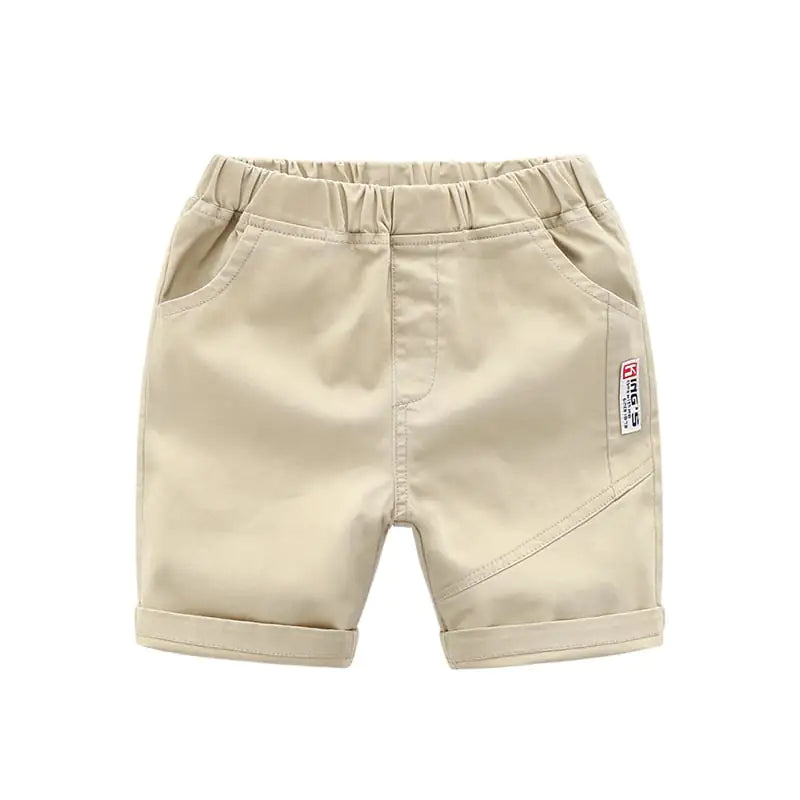 Beige breathable cotton summer pants for kids, featuring a side patch and rolled hems for a trendy look.