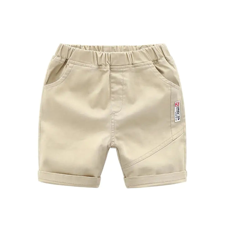 Beige breathable cotton summer pants for kids, featuring a side patch and rolled hems for a trendy look.