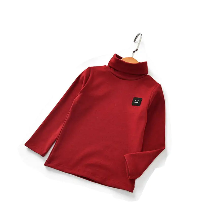 New Baby Long-Sleeved T-Shirt for Kids' Tops in deep red featuring a black face patch, made from soft cotton for cozy everyday wear.